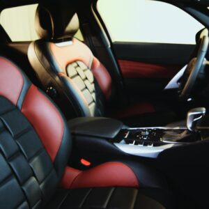 Explore the elegant luxury car interior featuring premium red and black leather seats, sophisticated dashboard, and modern design.